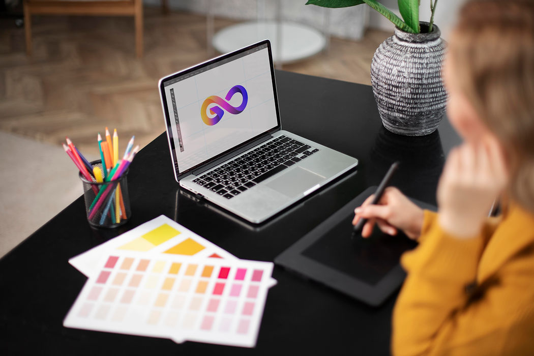 female-logo-designer-working-her-tablet-connected-laptop.jpg
