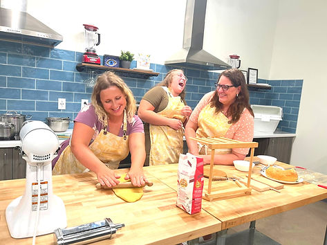 Guests making fresh pasta during a private pasta class at Danjoy's Homemade Pasta in Katy, TX