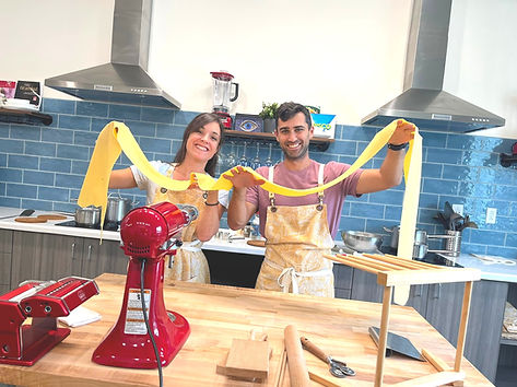Couple making fresh pasta during a hands-on pasta class at danjoy's Homemade Pasta in Katy, TX