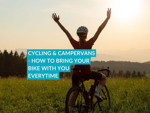 a person on a bike in a field  she has  a campervan