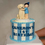 Thumbnail: Simple Blue Striped Birthday Cake with Customised Figurine