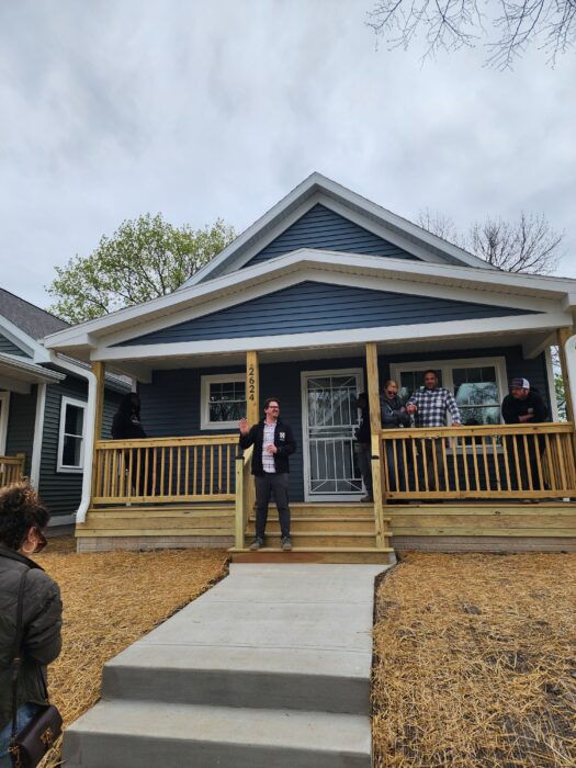 housing tour in Milwaukee, with local advocate on porch