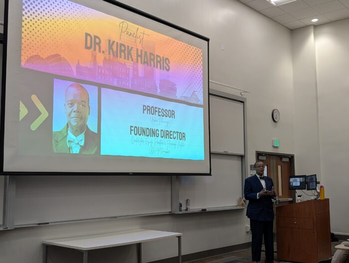 Dr. Kirk Harris presents on community land trusts at Marquette University