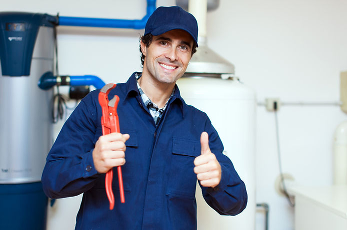 Plumber smiling holding thumbs up