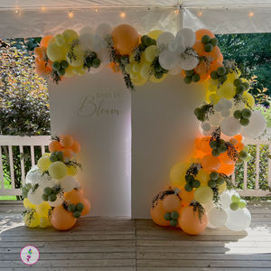 Baby in Bloom baby shower backdrop with a pastel yellow, peach, eucalyptus green, and white organic balloon garland with fresh eucalyptus and baby's breath at The Mansion of Saratoga.