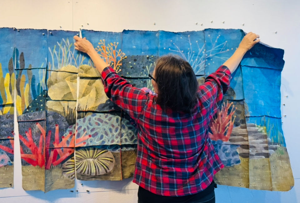 woman holds up reef
