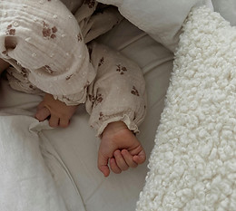 Baby sleeping in cot.