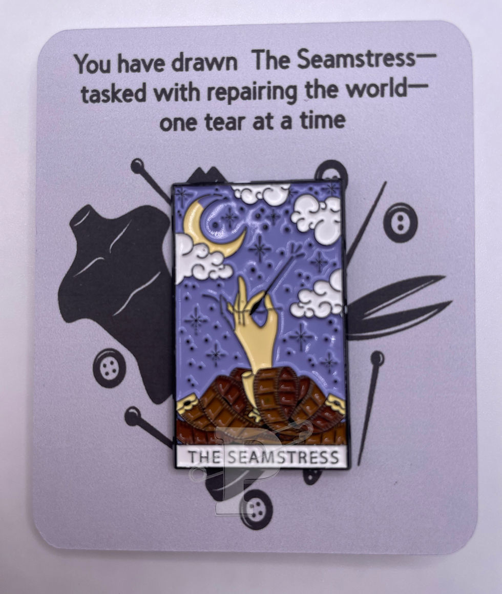 A flat card that reads "You have drawn the seamstress..one tear at a time" with a seamstress tarot card pin attached