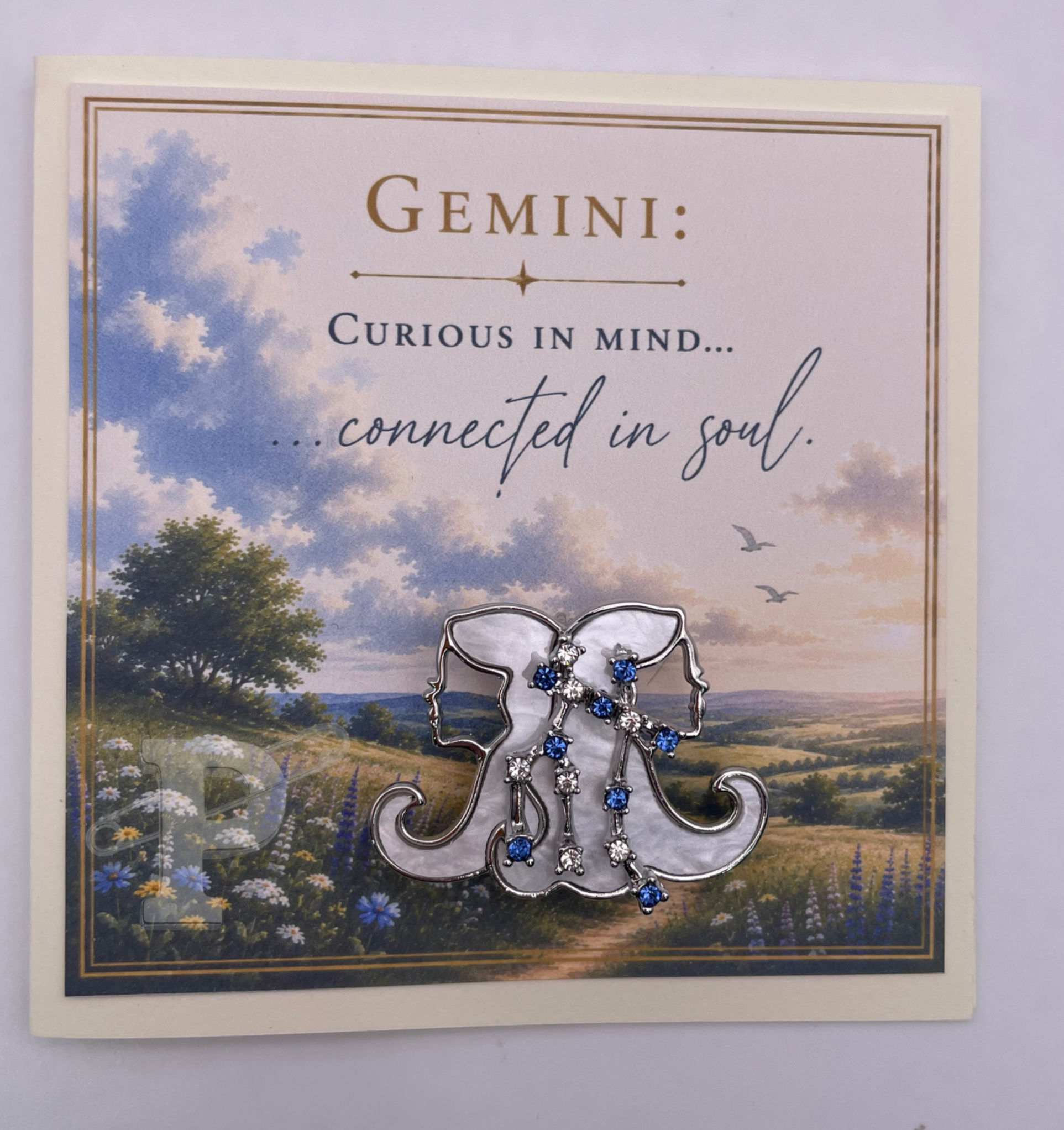 Zodiac mini greeting card with a removable Gemini brooch featuring sentiment, "Curious in mind... connected in soul."