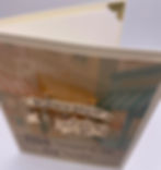 Top view of greeting card with detachable “Born to Shop” brooch featuring charms of a purse, money, shopping bag and more