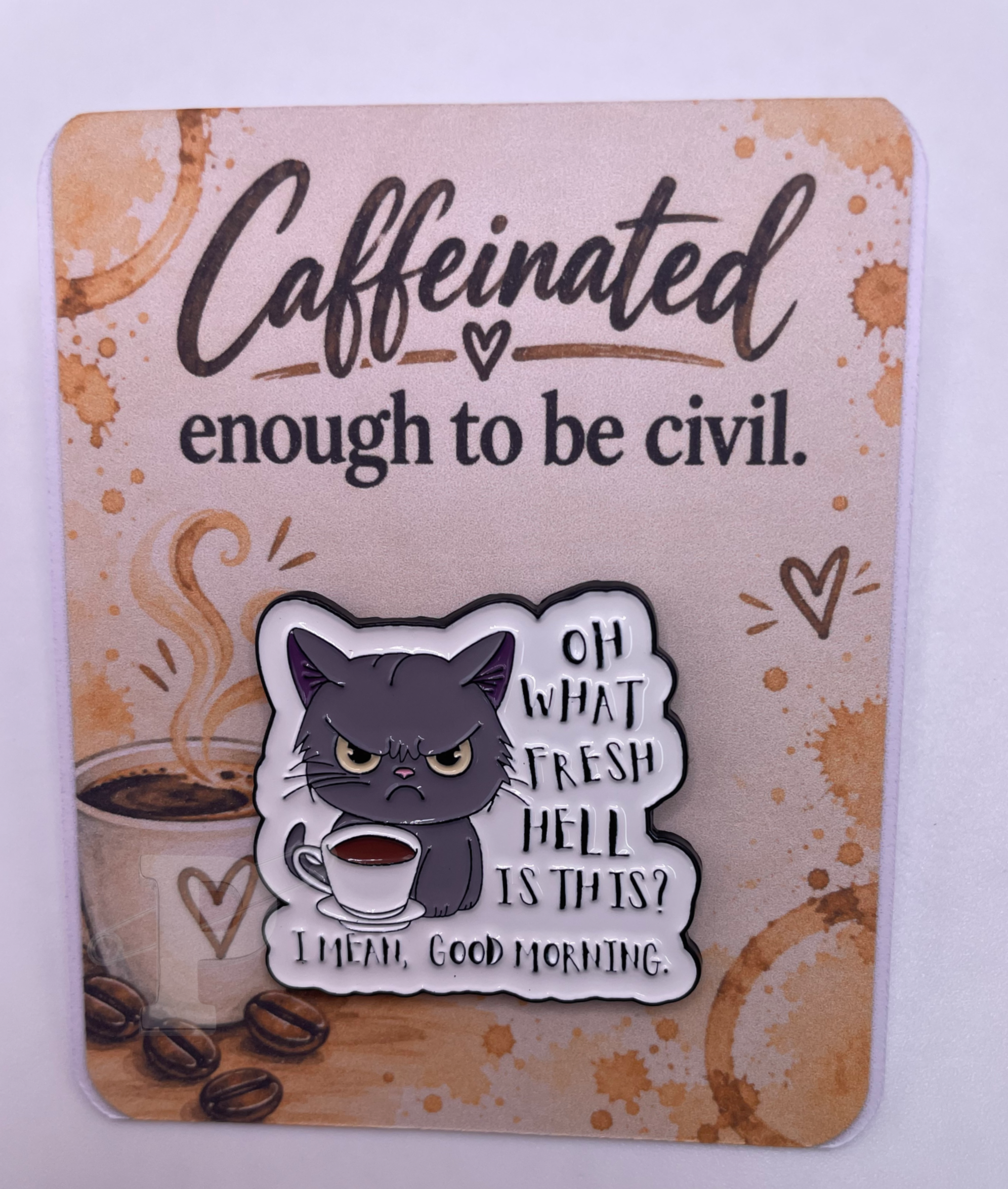 Grumpy cat coffee enamel pin on caffeinated humor card.
