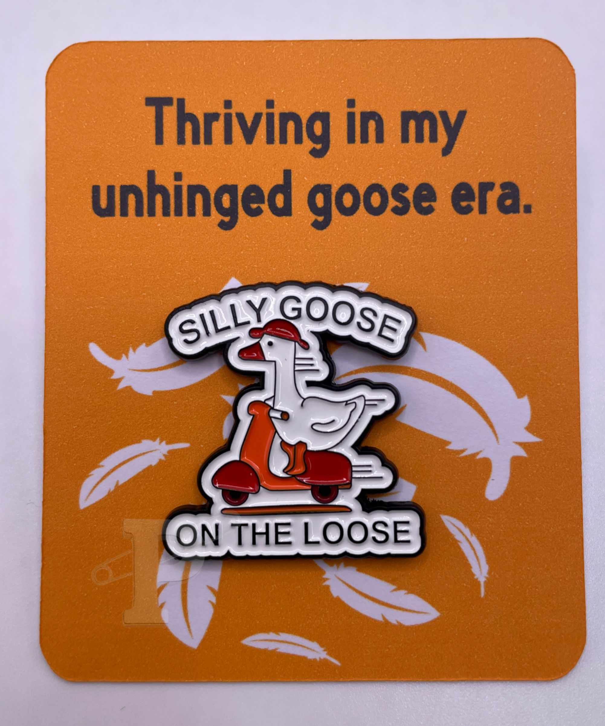 Flat card that reads “Thriving in my unhinged goose era” with a silly goose on the loose pin