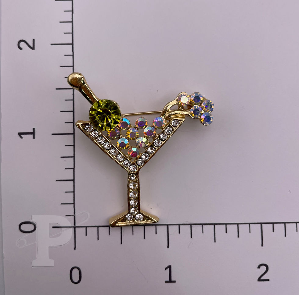 Thumbnail: martini glass brooch with iridescent crystal accents, an olive-green gem, and crystal garnish, shown beside a ruler for size