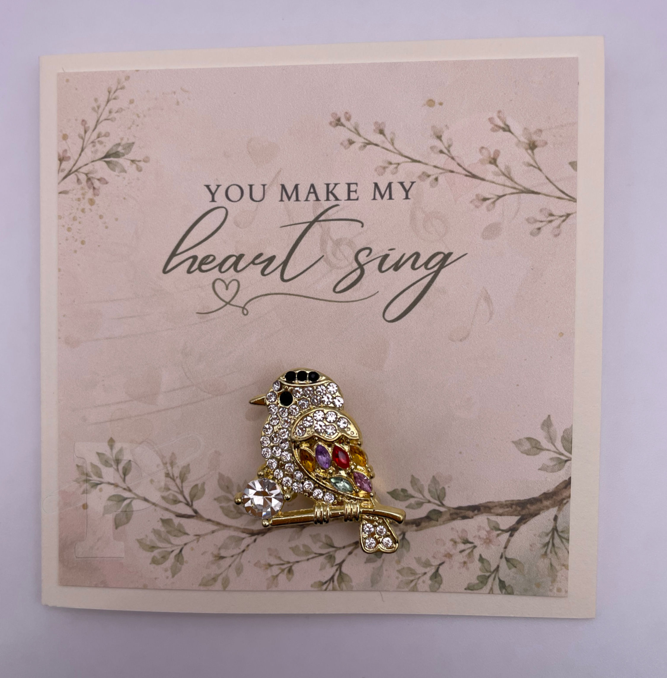 Mini love greeting card featuring a jeweled songbird brooch with the sentiment, "You make my heart sing."