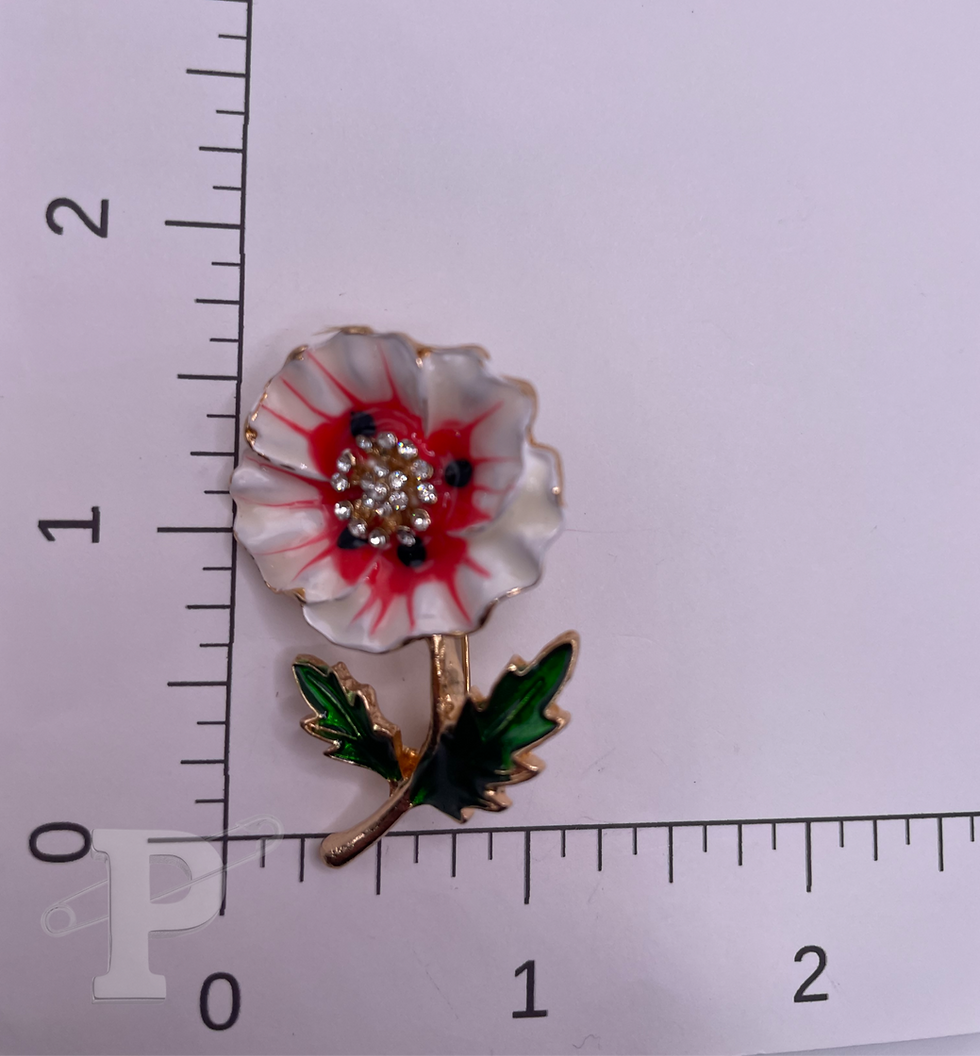 Thumbnail: Poppy flower brooch shown with ruler for size reference.