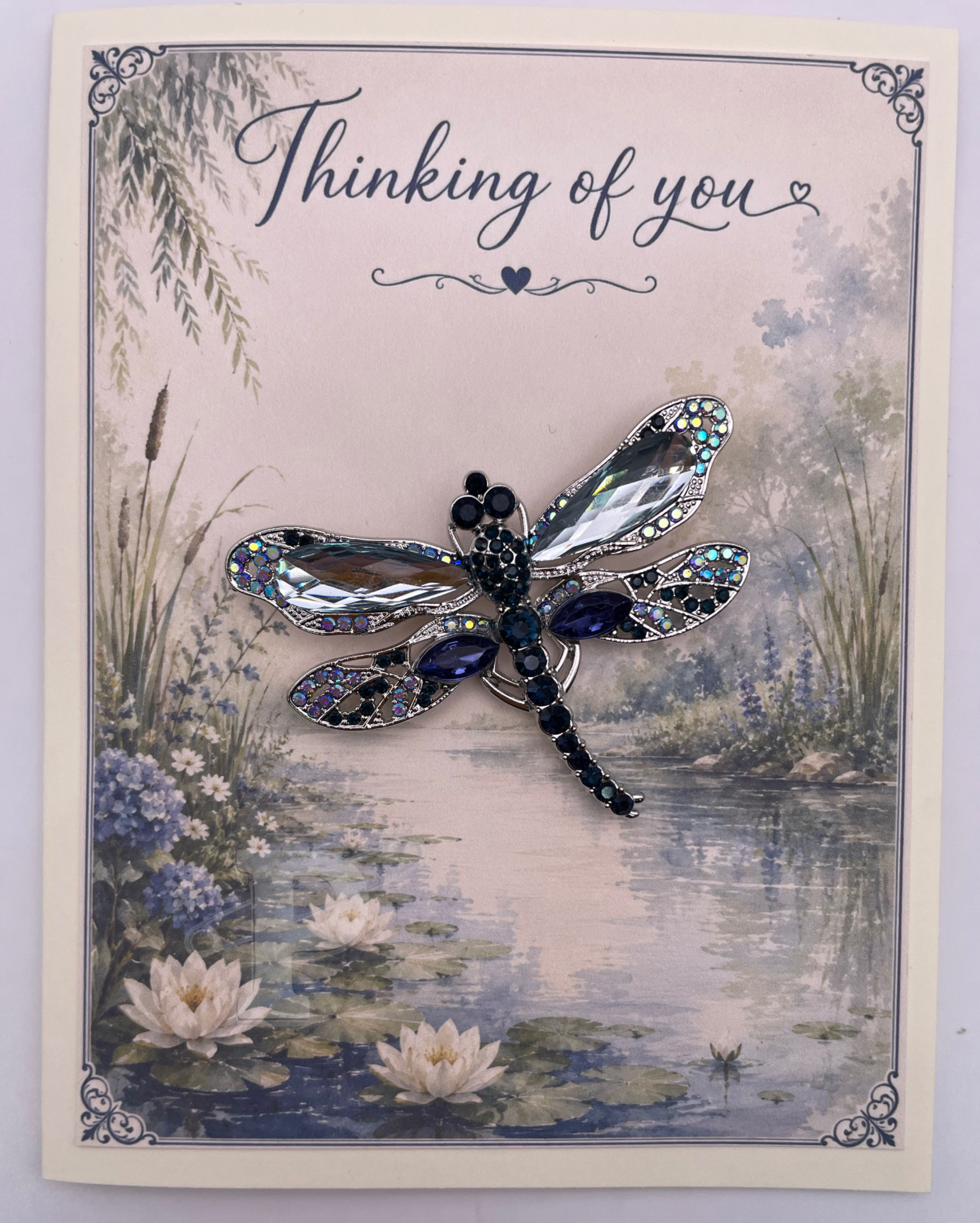 Dragonfly brooch on a Thinking of You keepsake greeting card featuring a peaceful watercolor pond with blooming water lilies.