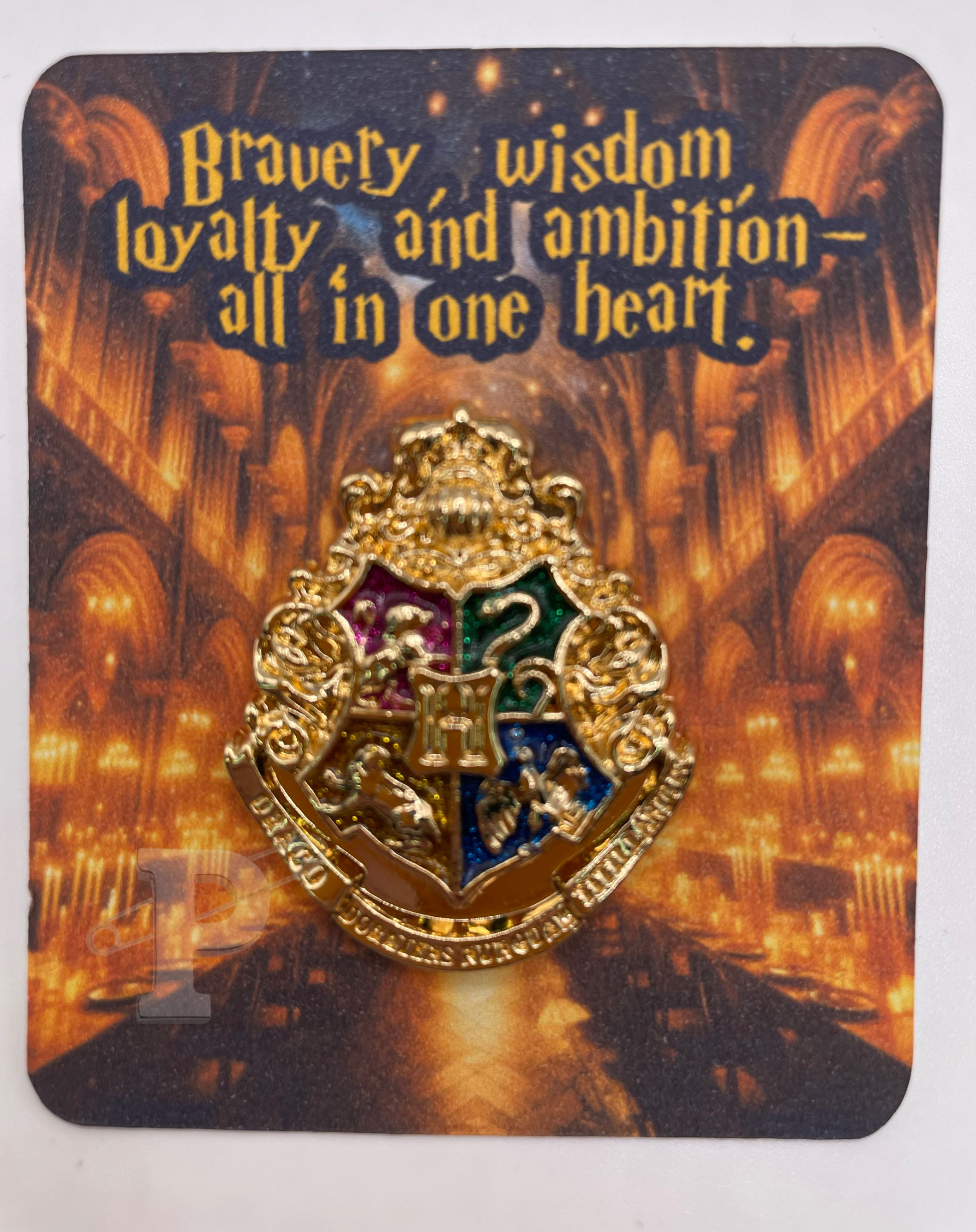 Flat card that reads “Bravery, loyalty, wisdom, and ambition — all in one heart.” with crest pin attached.