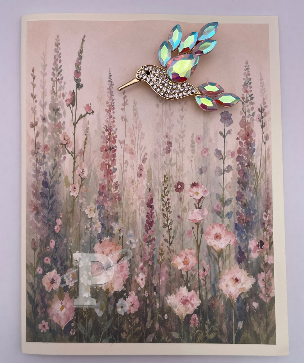 Greeting card with removable crystal hummingbird brooch on a watercolor wildflower background.
