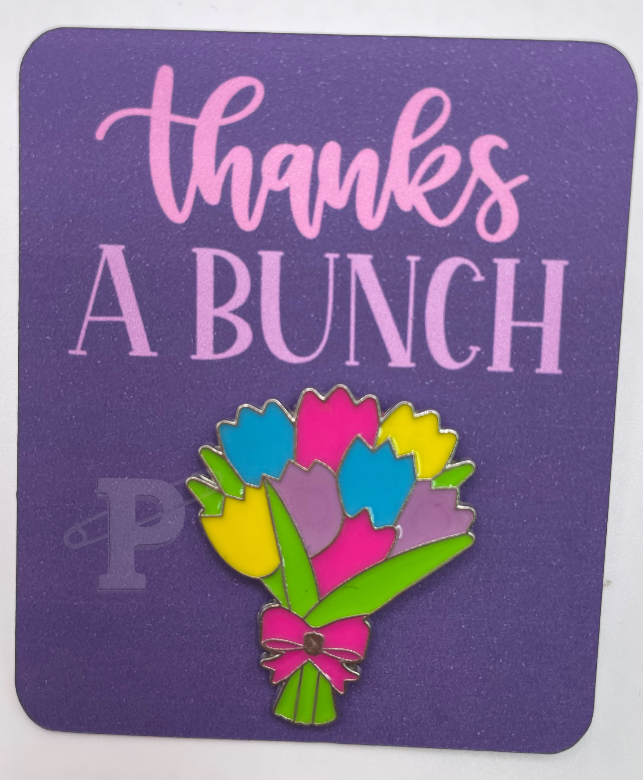 Flat card that reads “Thanks a bunch.” with tulip bouquet lapel pin.