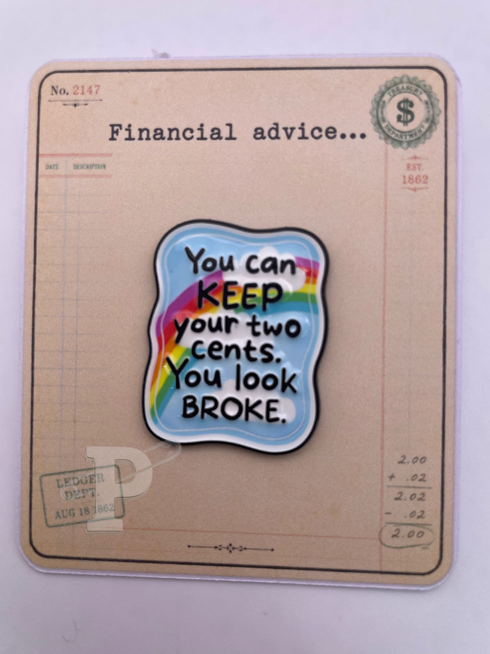 Funny "Keep Your Two Cents" enamel pin on a vintage ledger-inspired pin card with the sentiment "Financial advice..."
