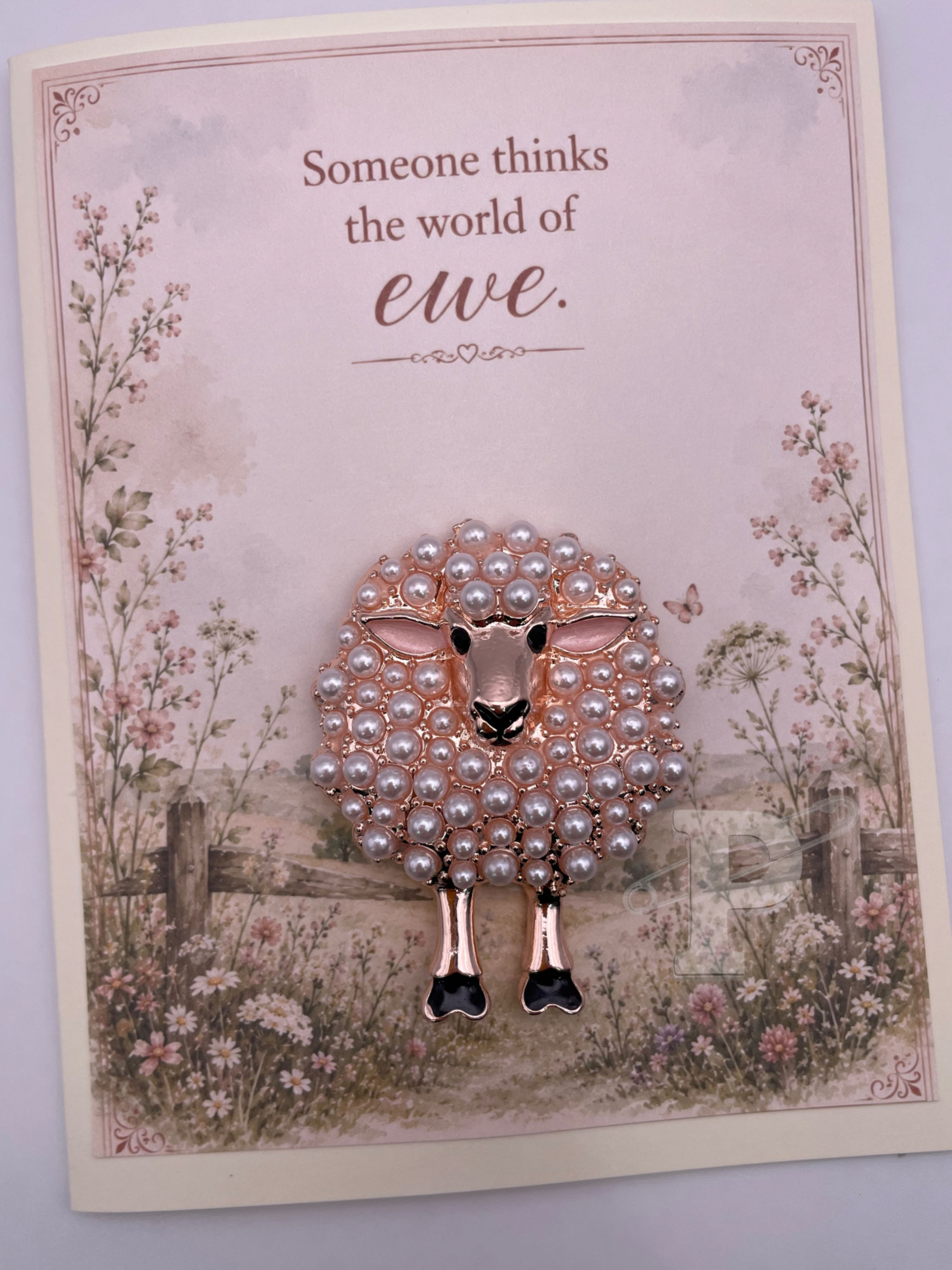 Greeting card with removable pearl sheep brooch and the sentiment, "Someone thinks the world of ewe."