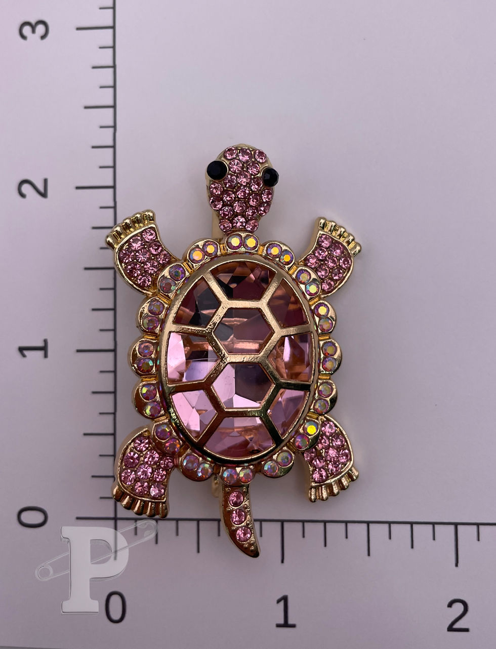 Thumbnail: Crystal turtle brooch shown with ruler for size reference.