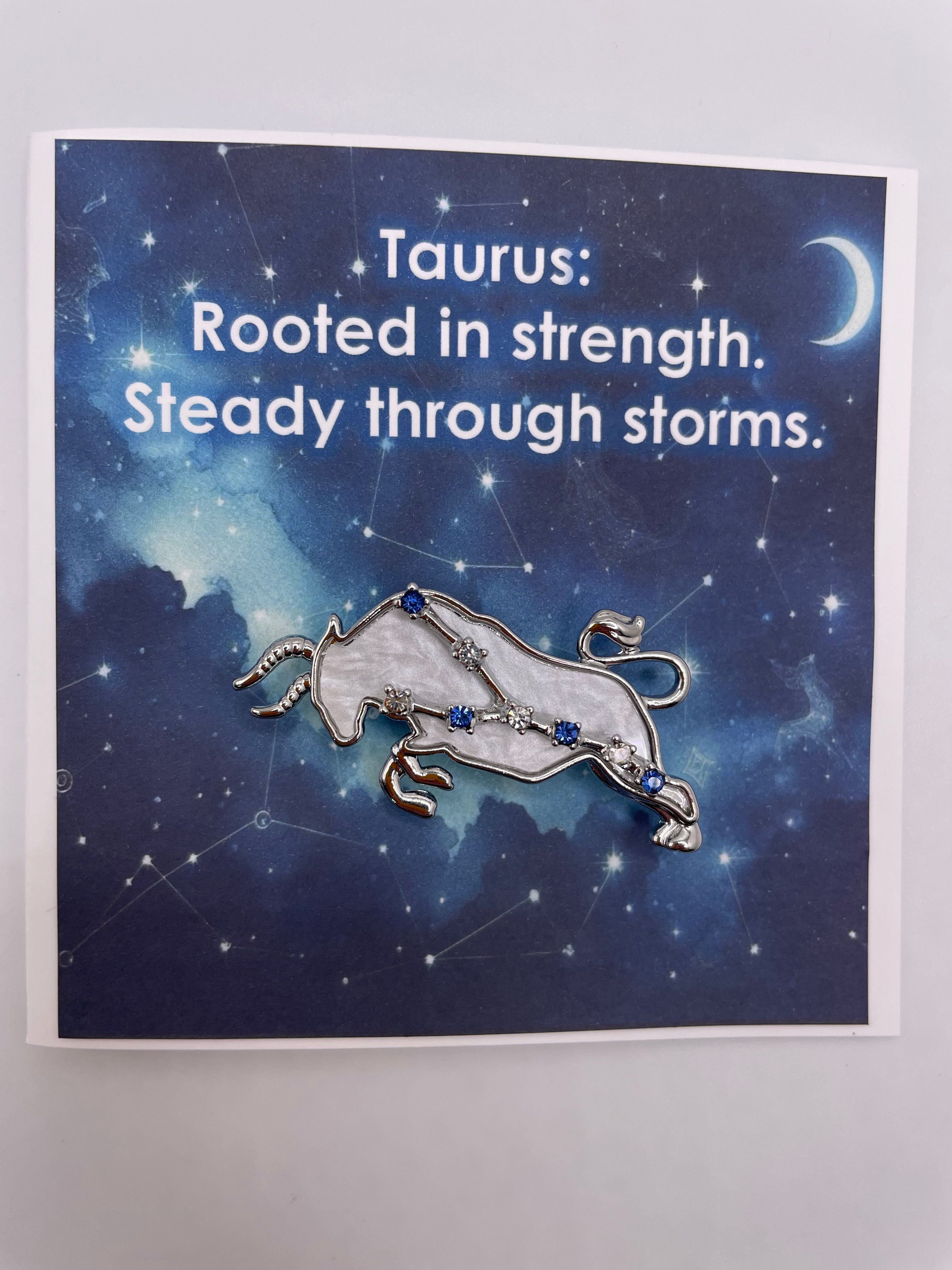 Mini card with text "Taurus: Rooted in strength. Steady through storms." with removable Taurus brooch attached.