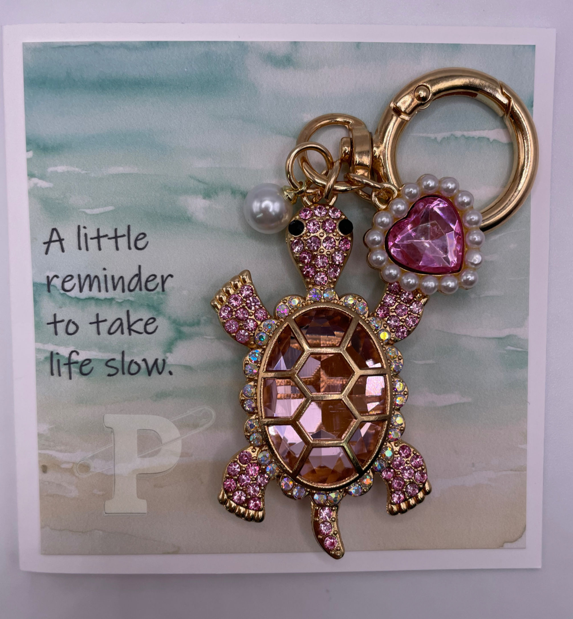 Mini card that reads, "A little reminder to take life slow," with turtle keychain.