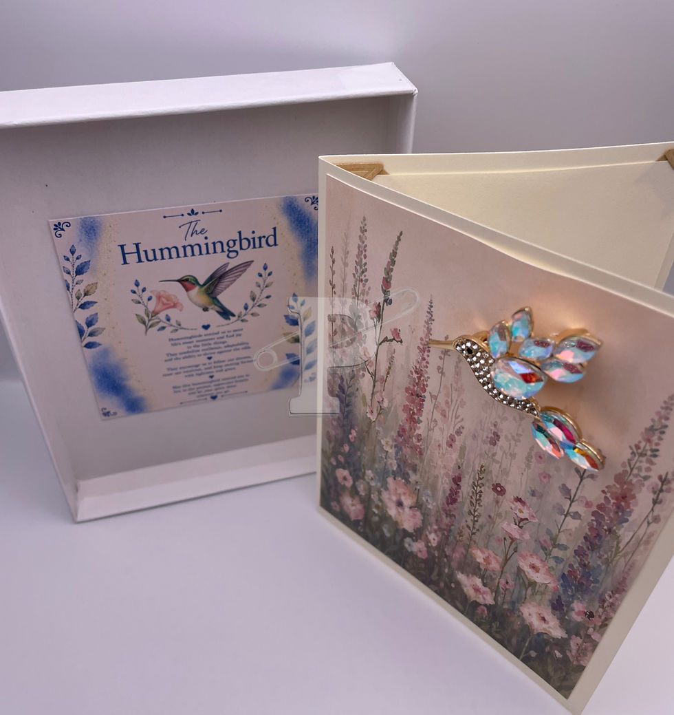 Open gift box displaying a handmade card with removable crystal hummingbird brooch and coordinating Hummingbird Symbol Meanin