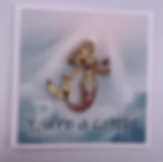 Mini card that reads “You’re a catch!” with mermaid brooch attached.