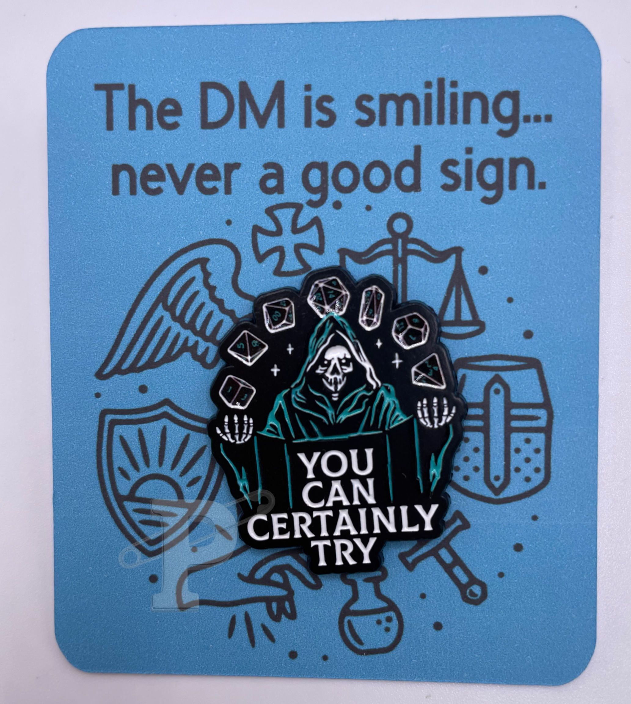 Flat card with pin of dungeon master and phrase ‘You can certainly try.’ Card  reads ‘The DM is smiling… never a good sign'