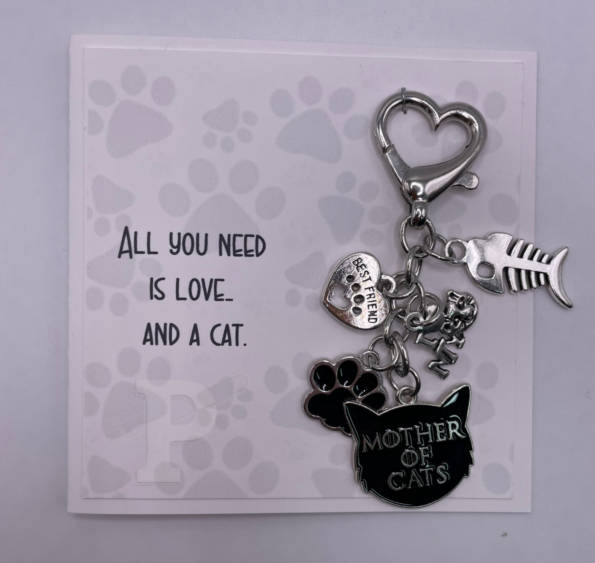 Mini card that reads, "All you need is love and a cat," with cat themed "Mother of Cats" keychain.
