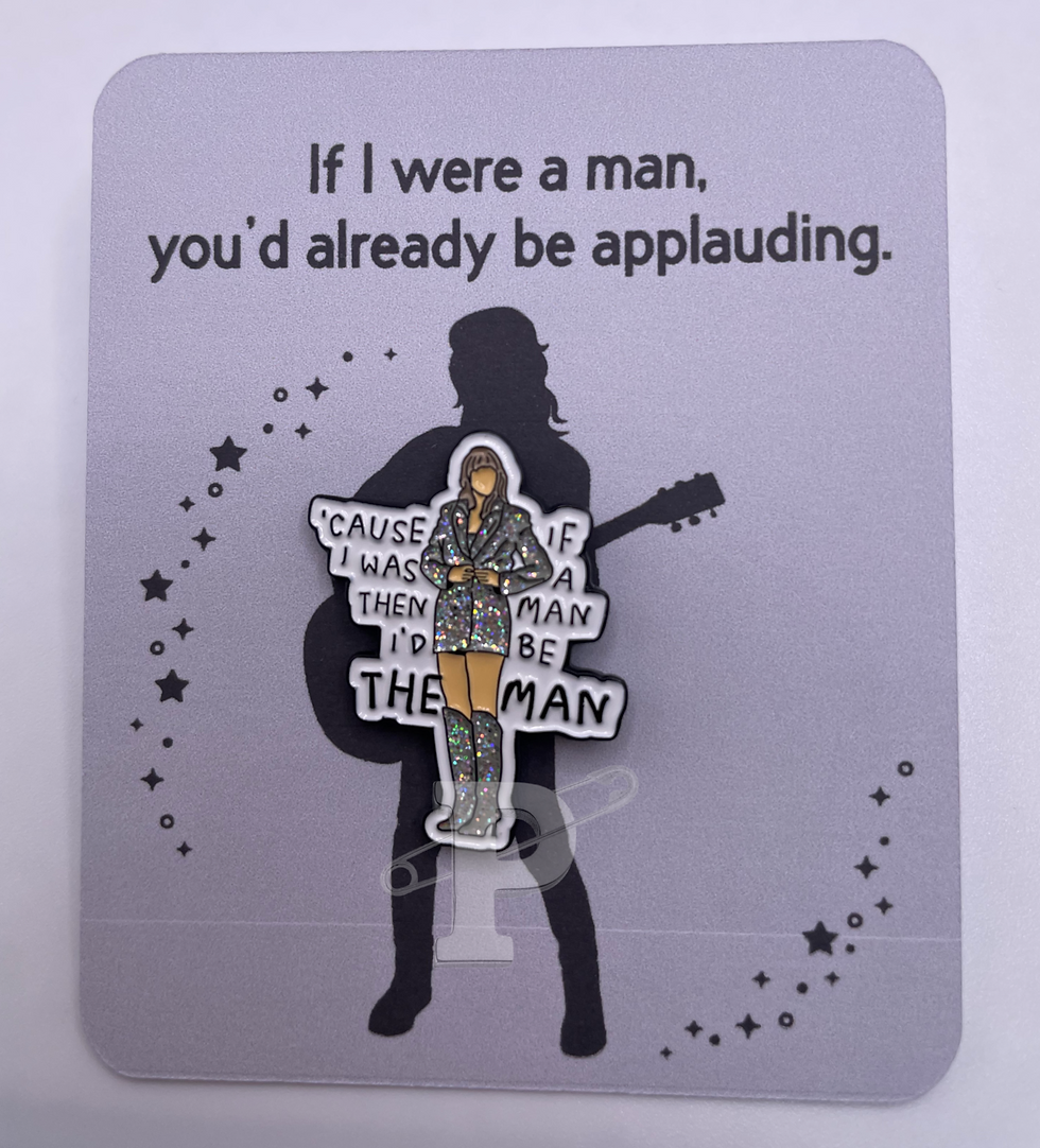 A flat card that reads "If I were a man, you'd already be applauding" with a 'Cause if I was a man then I'd be THE MAN" pin