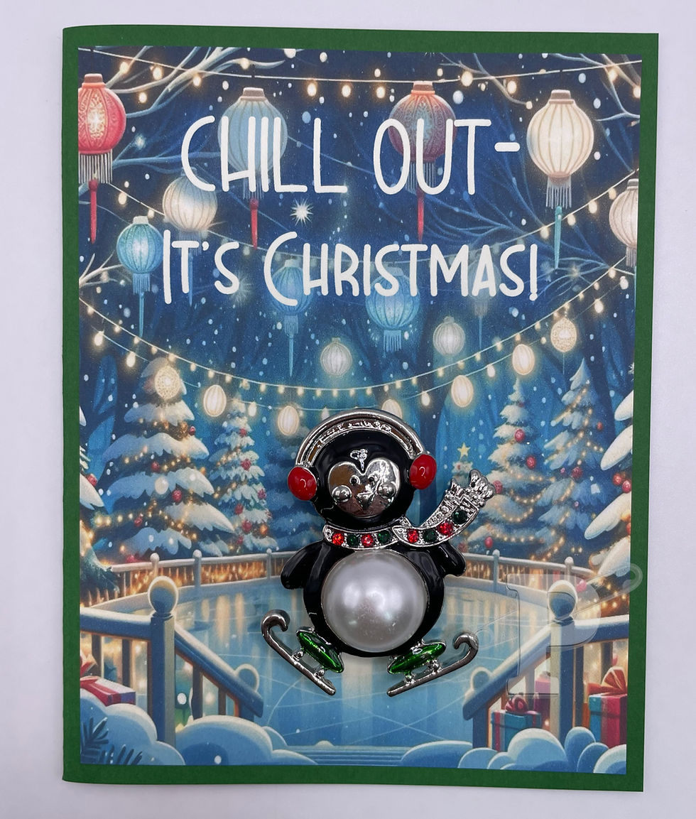 Christmas card with detachable penguin brooch, snowy lantern-lit skating scene, and “Chill Out – It’s Christmas!” text.