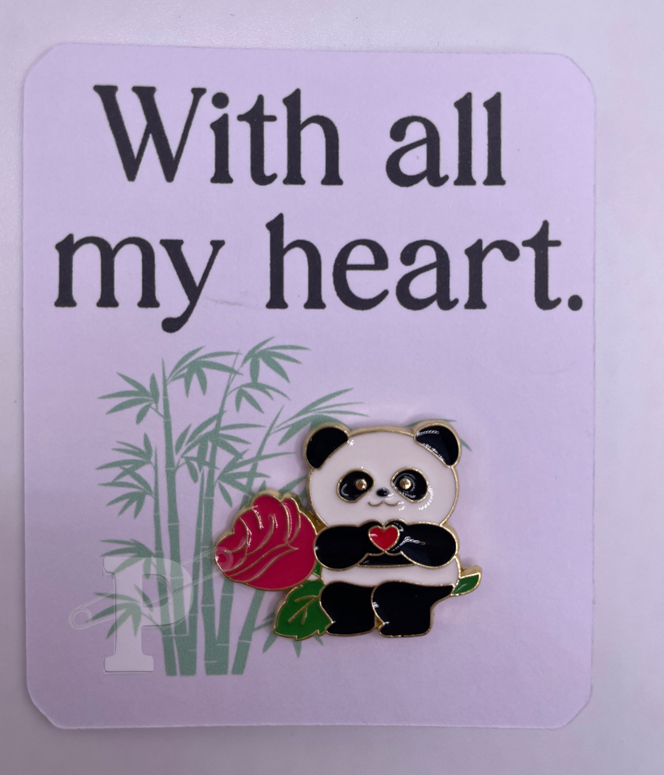 Flat card that reads “With all my heart” with a panda holding a rose pin attached.