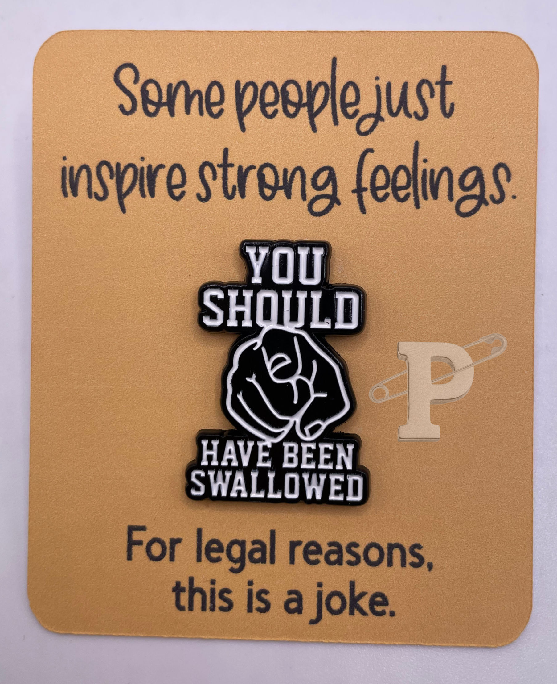 Flat card that reads, “Some people just inspire strong feelings. with “You should have been swallowed" pin