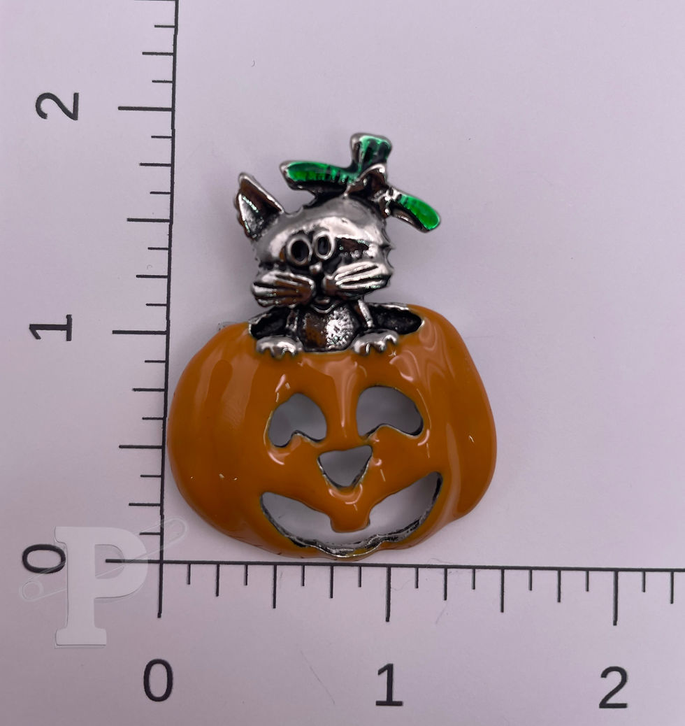 Thumbnail: Cat in jack-o'-lantern enamel brooch with orange pumpkin and silver cat details, shown beside a ruler for size reference.