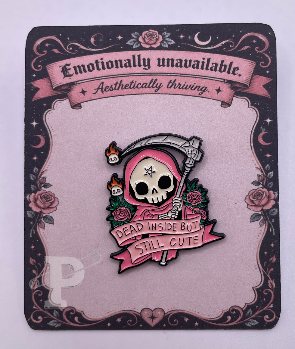 Pink grim reaper enamel pin reading “Dead inside but still cute” on a gothic card