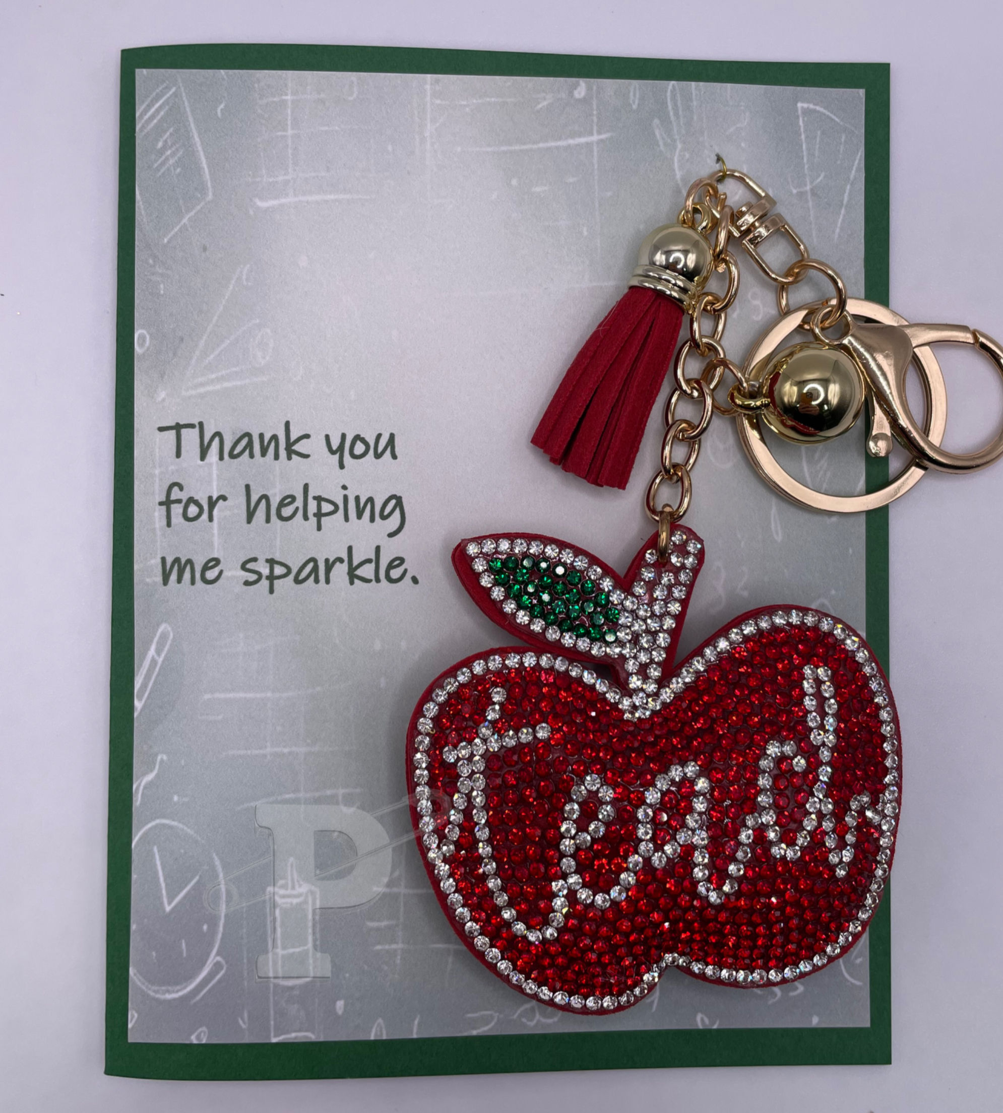 Greeting card with red rhinestone apple teacher keychain that reads, "Thank you for helping me sparkle."