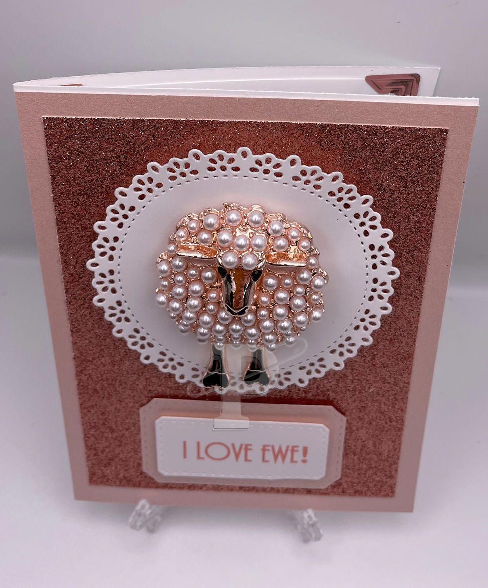 Handcrafted greeting card with pink pearled sheep brooch set in rose gold, mounted on a laced white circle over rose gold gli