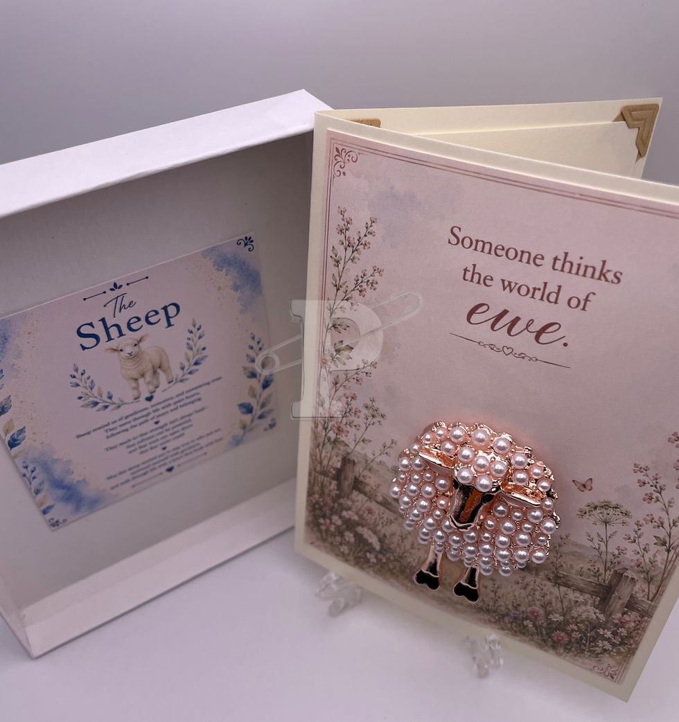 Open gift box displaying a handmade card with removable pearl sheep brooch and coordinating Sheep Symbol Meaning keepsake car