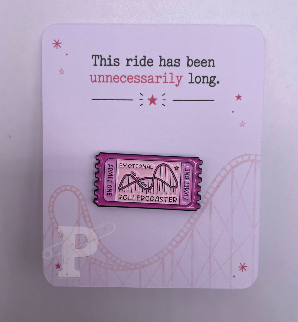 Emotional Rollercoaster ticket enamel pin displayed on a pink card with the sentiment “This ride has been unnecessarily long.