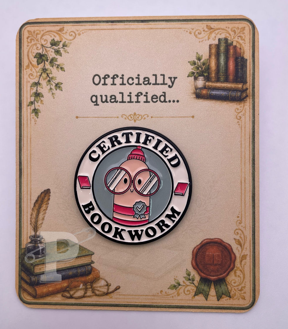 Certified Bookworm enamel pin on a vintage library-inspired pin card with the sentiment "Officially qualified..."