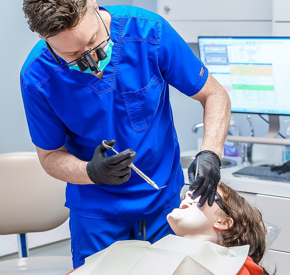 Dentist using tool on patient
