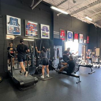 Kevin Medina’s personal training facility in Vaughan, showing clients using treadmill, rowing machine, and other workout equipment.