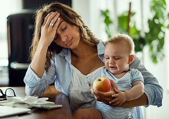 young-mother-feeling-exhausted-while-being-with-her-baby-working-home.jpg