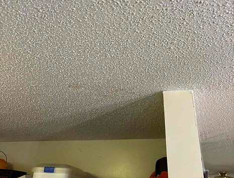 Textured popcorn ceiling showing a small stain before repair and repainting in Colonial Village, Durham NC 27704