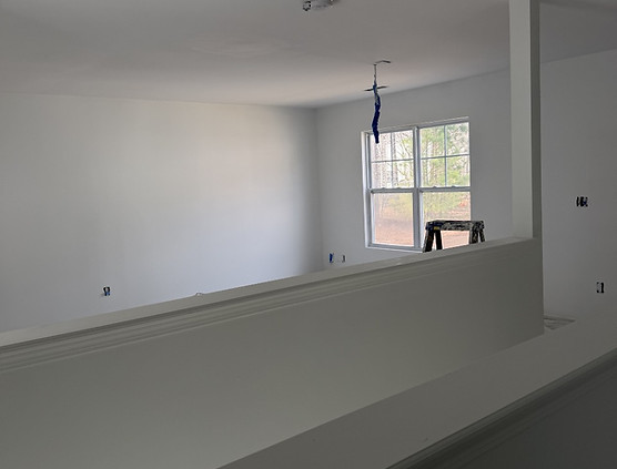 Living room after interior painting in Pineview Zebulon NC with fresh white walls and smooth ceiling finish.