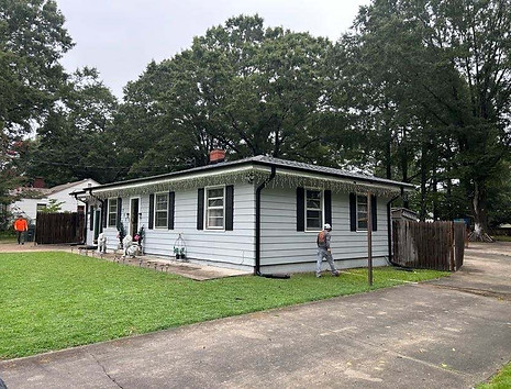 Exterior painter in Clayton NC painting upper trim and window shutters on home in Neuse Colony 27520.
