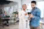 Woman showing a man something on her phone at work